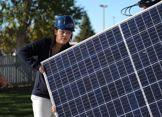 Woman installing solar panel